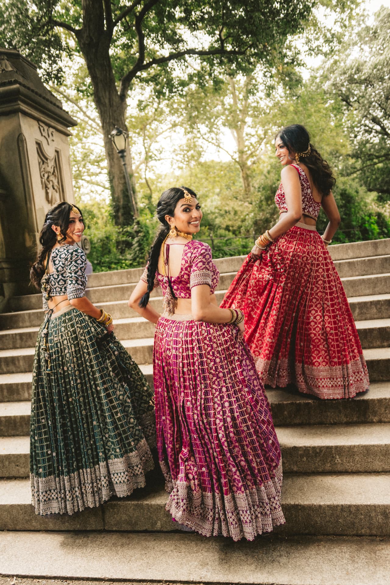 Three models climbing the steps, looking back over their shoulders